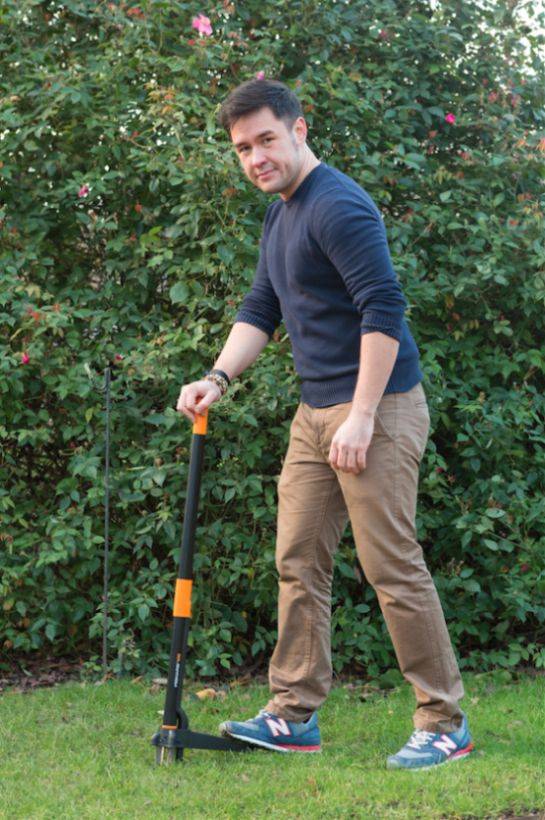 Man in garden holding a weed killer