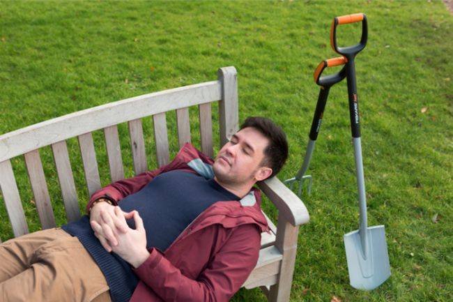 Man relaxing with eyes closed on a bench